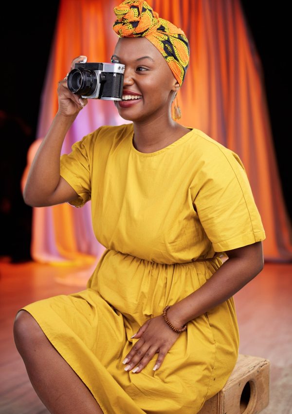 Camera, studio and happy black woman shooting photo, picture or photography of creative fashion des.