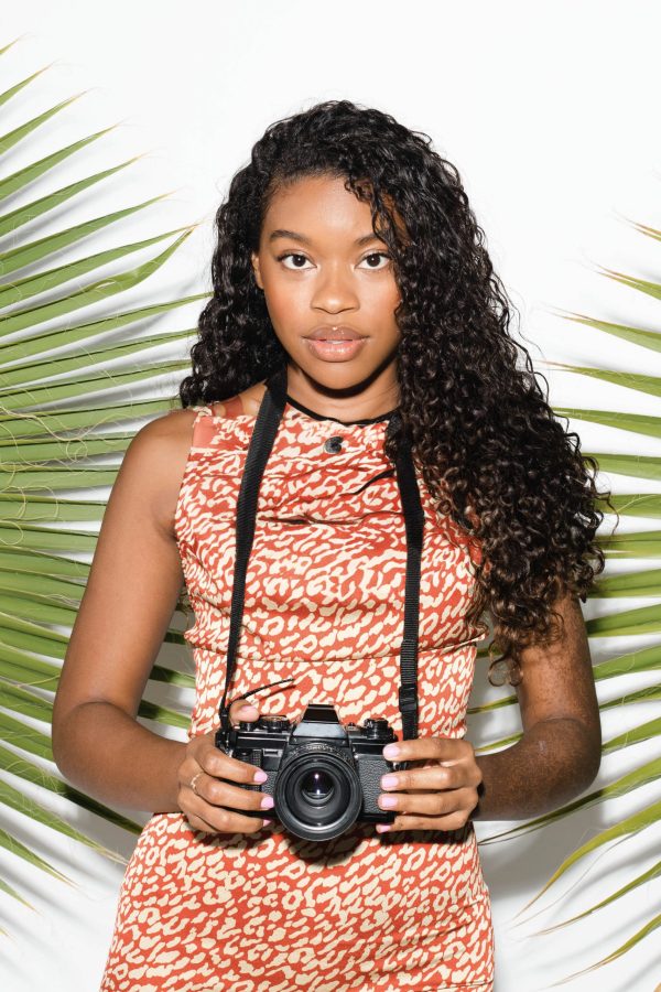 Beautiful black woman with an analog camera